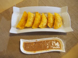 Empanadas de Pipián - filled with potatoes and served with a spicy peanut sauce